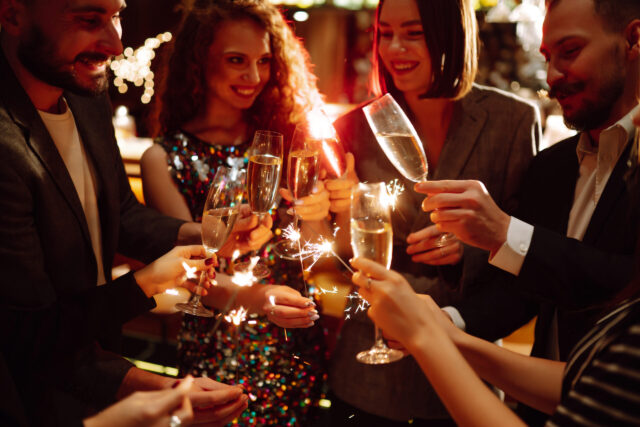 New Year's Eve celebration friends cheering with champagne