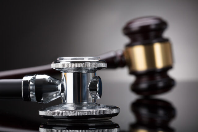 Close-up Of A Stethoscope In Front Of Gavel